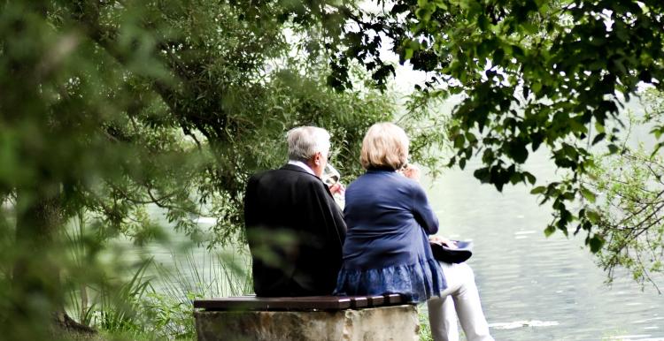 A couple sitting on a stone