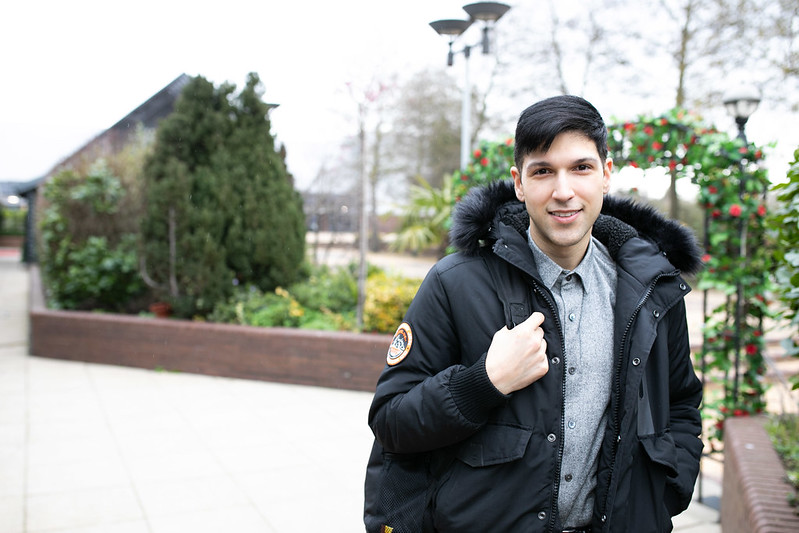 Young male is seen smiling outside