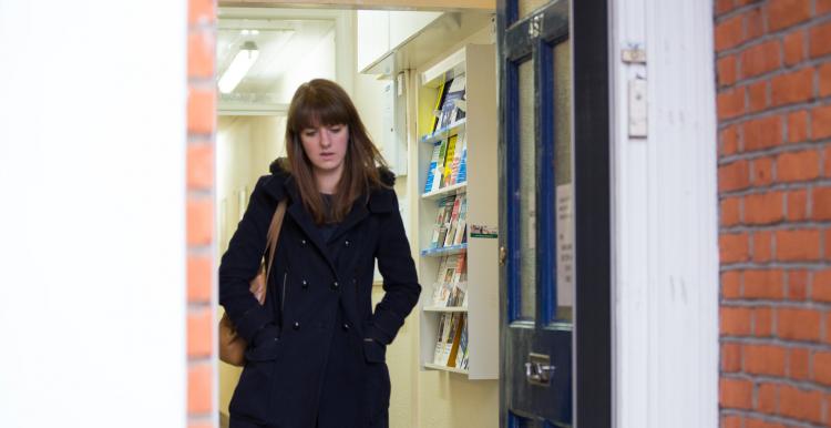 A lady walking by a door