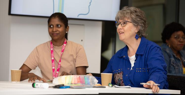 Two women attentive in a meeting.