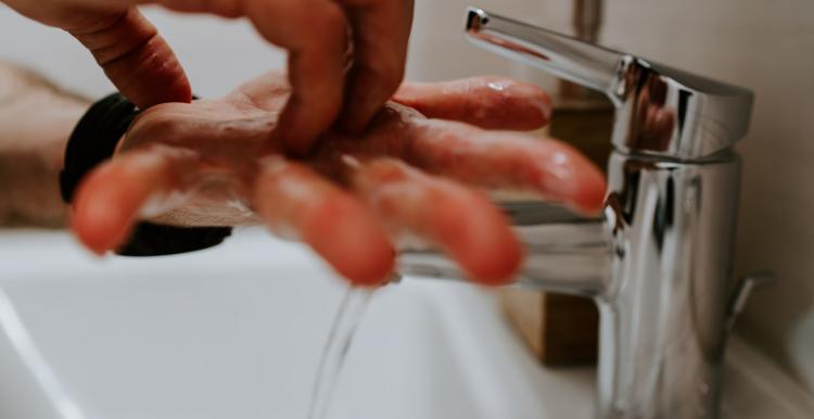 washing hands under tap