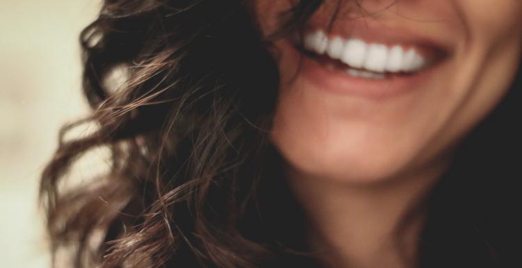 a woman smiling showing her teeth