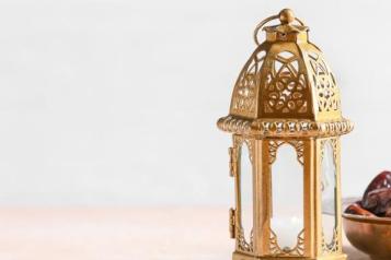 Ramadan 2023: Islamic lamp, dates in bowl displayed on table.
