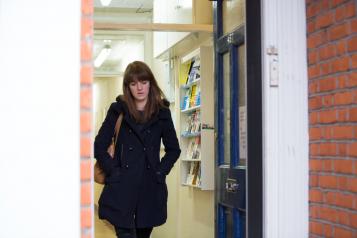 A lady walking by a door