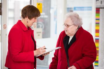 Two women speaking to one another