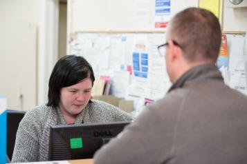 Man talking to a receptionist