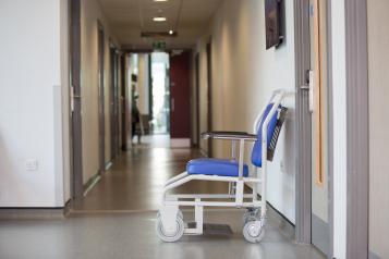 Patient Wheelchair in Hospital Corridor