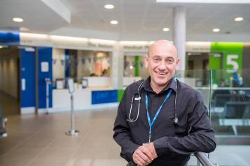 Man standing with stethoscope around his neck