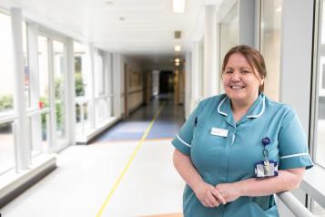 Smiling Nurse standing in a corridor