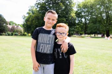 Two young boys on the grass