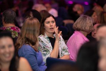 A group of women sitting at an event