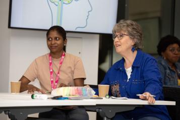 Two women attentive in a meeting.