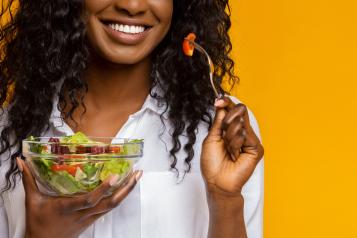 Woman eating salad.