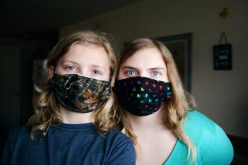 Two young people wearing face masks