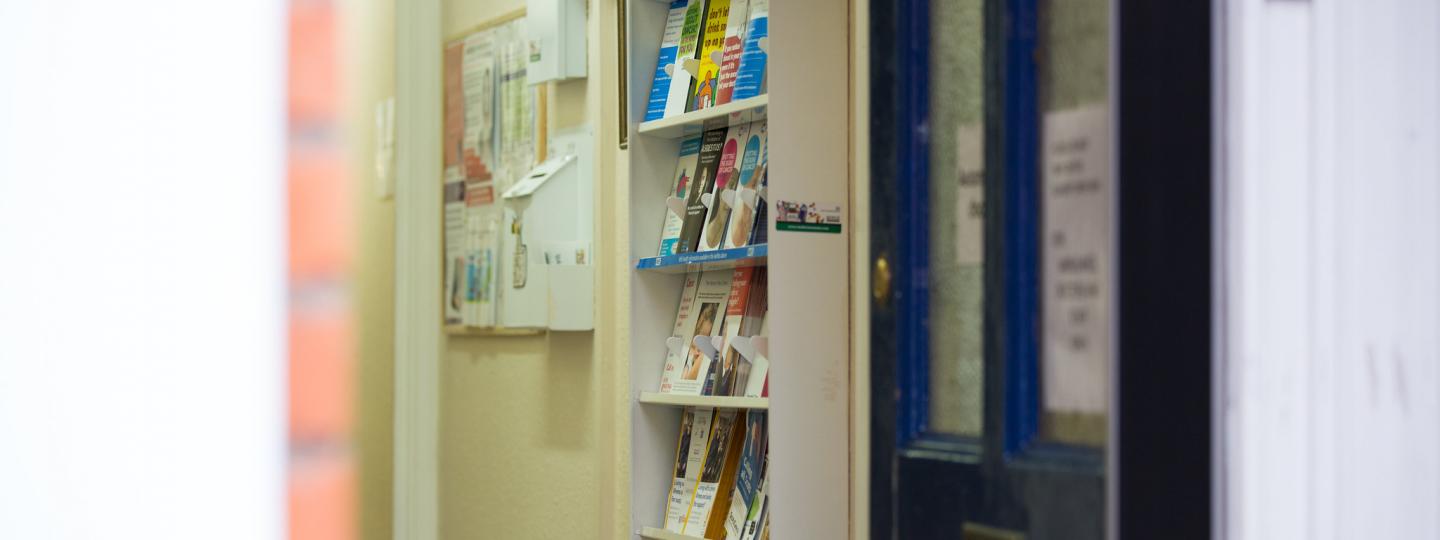 Blue door with a shelf full of leaflets