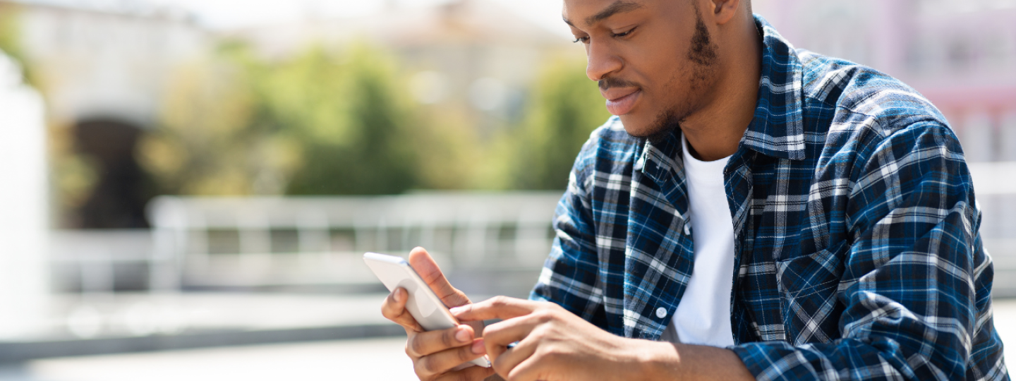 Man on his mobile phone, texting. 