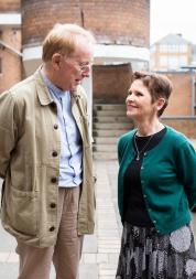 A man and a woman smiling and talking to each other